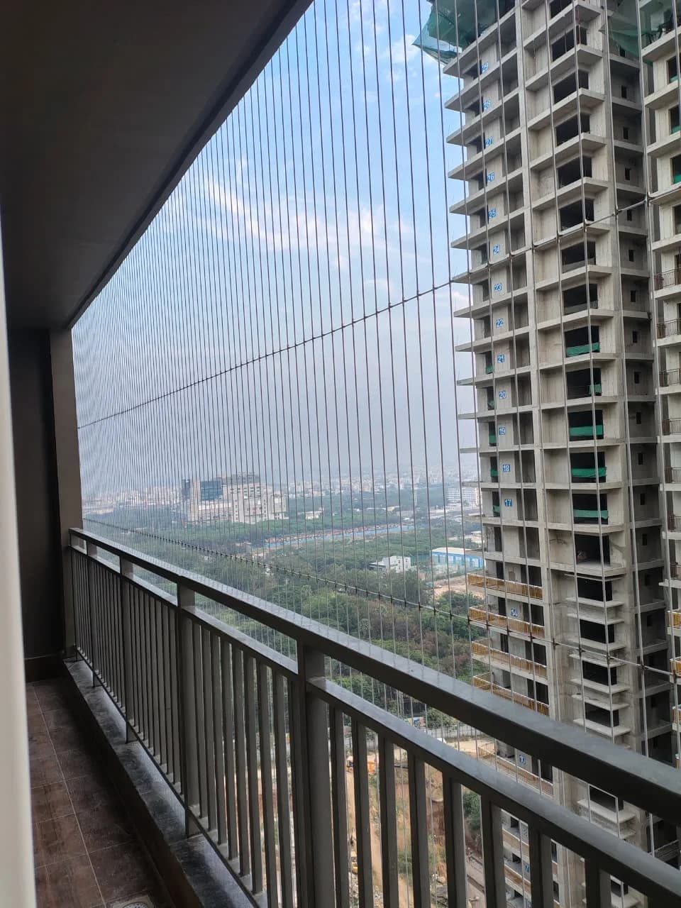 Completed invisible grill installation across a balcony opening