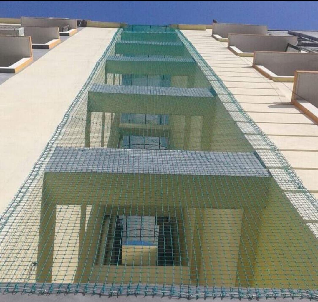Building shaft safety net between balcony stacks