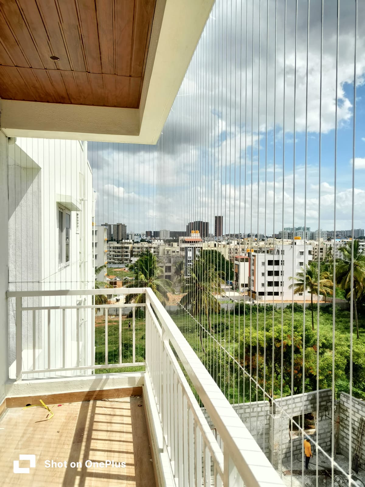 Balcony invisible grill installation overlooking the city